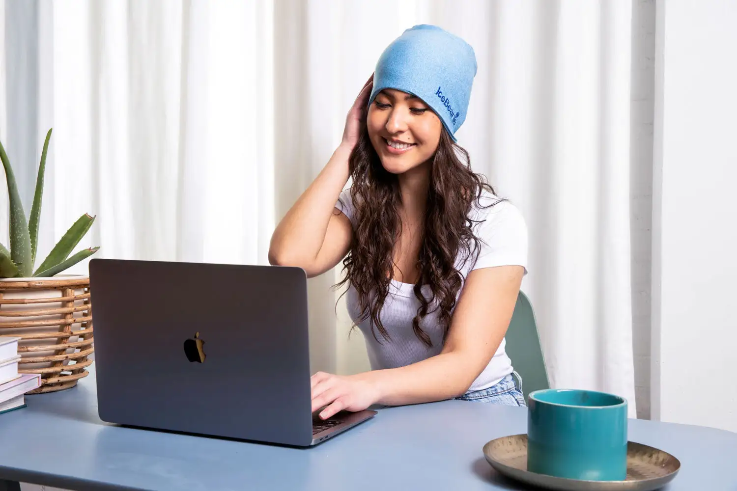 Woman comfortably wearing IceBeanie while working at desk