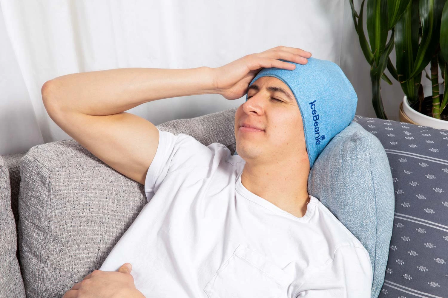 Man relaxing comfortably with IceBeanie on the couch
